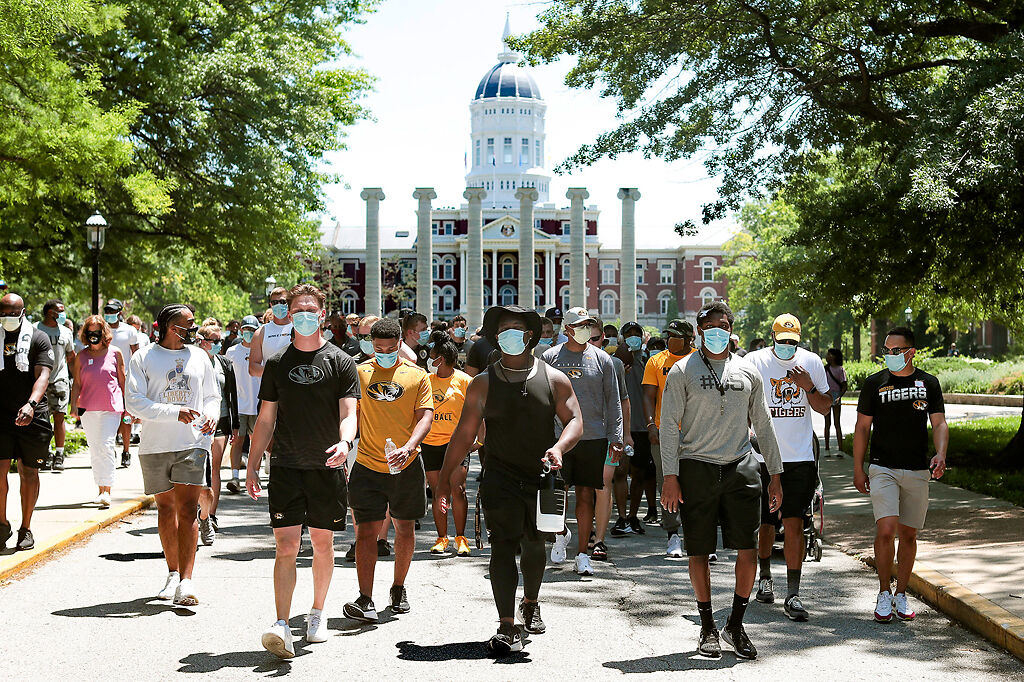 Missouri players, coaches and staff march